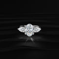 Oval Diamond Triology Ring In Floral Setting With Side Pear