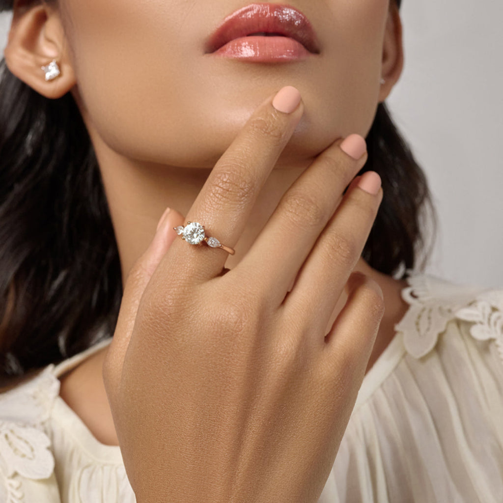 Round Floral Solitaire Ring With Side Marquise Stone